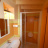 11) bathroom with box shower, toilet, bidet, sink with cabinet